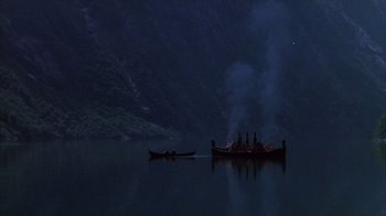 Movie still from “The Island at the Top of the World” (1974), directed by Robert Stevenson – Two boats in a body of water at night; Extreme Wide shot, High angle