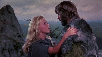 Movie still from “The Island at the Top of the World” (1974), directed by Robert Stevenson – A man and a woman are standing in a field; Close Up shot, Low angle