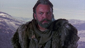 Movie still from “The Island at the Top of the World” (1974), directed by Robert Stevenson – A man with a beard and a fur coat on; Close Up shot, Low angle