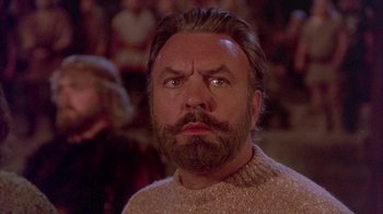 Movie still from “The Island at the Top of the World” (1974), directed by Robert Stevenson – A man with a beard and a sweater; Close Up shot, Low angle