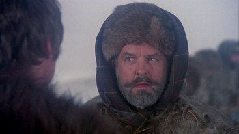 Movie still from “The Island at the Top of the World” (1974), directed by Robert Stevenson – A man with a beard wearing a fur coat and a hat; Close Up shot, Over the shoulder angle