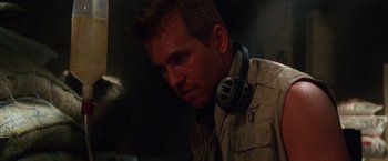 Movie still from “The Island of Dr. Moreau” (1996), directed by Richard Stanley – A person wearing headphones; Close Up shot, Over the shoulder angle