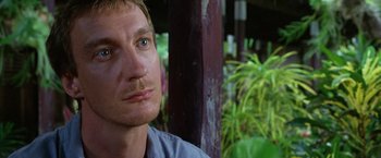 Movie still from “The Island of Dr. Moreau” (1996), directed by Richard Stanley – A person with blue eyes; Close Up shot, Over the shoulder angle