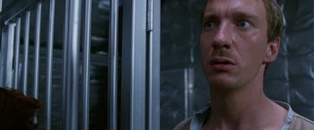 Movie still from “The Island of Dr. Moreau” (1996), directed by Richard Stanley – A person looking at the camera; Close Up shot, Low angle