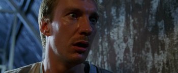 Movie still from “The Island of Dr. Moreau” (1996), directed by Richard Stanley – A man's face looking up at the sky; Close Up shot, Low angle