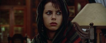 Movie still from “The Island of Dr. Moreau” (1996), directed by Richard Stanley – A person wearing a hooded scarf; Close Up shot, Low angle