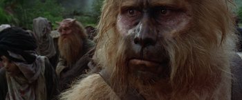 Movie still from “The Island of Dr. Moreau” (1996), directed by Richard Stanley – The face of an animal with long hair; Close Up shot, Over the shoulder angle