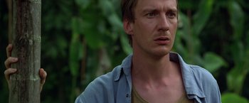 Movie still from “The Island of Dr. Moreau” (1996), directed by Richard Stanley – A person wearing a blue shirt; Close Up shot, Low angle