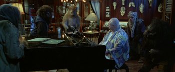 Movie still from “The Island of Dr. Moreau” (1996), directed by Richard Stanley – A man and a woman are playing a piano; Wide shot, High angle