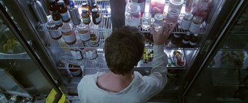Movie still from “The Island of Dr. Moreau” (1996), directed by Richard Stanley – A man is looking at jars on a shelf; Extreme Close Up shot, Overhead angle