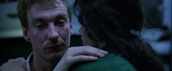 Movie still from “The Island of Dr. Moreau” (1996), directed by Richard Stanley – A man and a woman looking at one another; Close Up shot, Over the shoulder angle