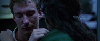 Movie still from “The Island of Dr. Moreau” (1996), directed by Richard Stanley – A man and a woman are looking at each other; Extreme Close Up shot, Over the shoulder angle