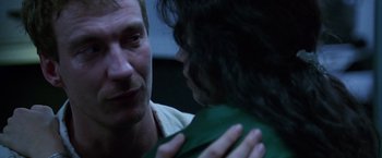 Movie still from “The Island of Dr. Moreau” (1996), directed by Richard Stanley – A man and a woman are looking at each other; Close Up shot, Over the shoulder angle