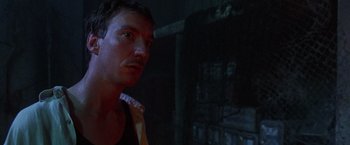 Movie still from “The Island of Dr. Moreau” (1996), directed by Richard Stanley – A person in a dark room; Close Up shot, Low angle