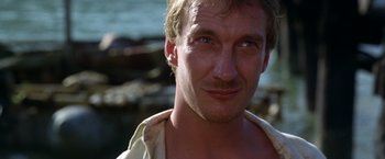 Movie still from “The Island of Dr. Moreau” (1996), directed by Richard Stanley – A person wearing a shirt; Close Up shot, Low angle