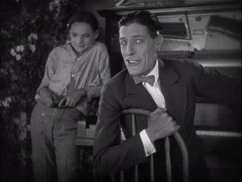 Movie still from “The Jazz Singer” (1927), directed by Alan Crosland – A black and white photo of a man and a woman; Medium shot, High angle