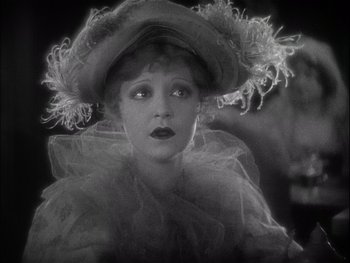 Movie still from “The Jazz Singer” (1927), directed by Alan Crosland – An old photo of a woman wearing a hat; Close Up shot, High angle