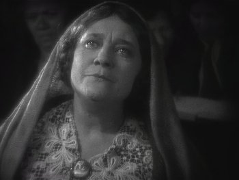 Movie still from “The Jazz Singer” (1927), directed by Alan Crosland – An older woman with a long veil over her head; Close Up shot, Low angle