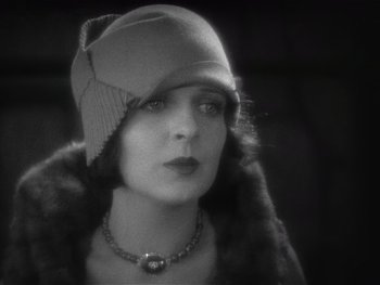 Movie still from “The Jazz Singer” (1927), directed by Alan Crosland – An old photo of a woman wearing a hat; Close Up shot, Low angle