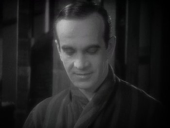 Movie still from “The Jazz Singer” (1927), directed by Alan Crosland – A black and white photo of a man in a robe; Close Up shot, High angle