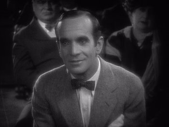 Movie still from “The Jazz Singer” (1927), directed by Alan Crosland – A man wearing a suit and a bow tie; Close Up shot, High angle