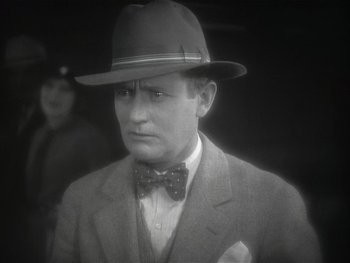 Movie still from “The Jazz Singer” (1927), directed by Alan Crosland – A man wearing a suit and a hat; Close Up shot, High angle