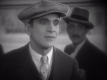 Movie still from “The Jazz Singer” (1927), directed by Alan Crosland – A man wearing a hat and a tie; Close Up shot, High angle