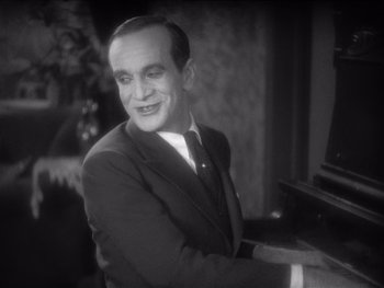 Movie still from “The Jazz Singer” (1927), directed by Alan Crosland – An older man in a suit and tie playing the piano; Close Up shot, High angle
