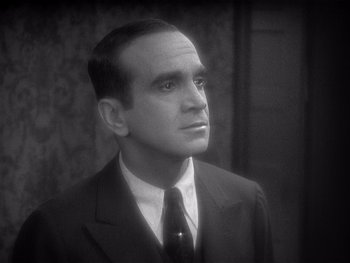 Movie still from “The Jazz Singer” (1927), directed by Alan Crosland – A man in a suit and tie looking to his left; Close Up shot, High angle