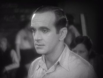 Movie still from “The Jazz Singer” (1927), directed by Alan Crosland – A black and white photo of a man in a white shirt; Close Up shot, High angle