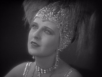 Movie still from “The Jazz Singer” (1927), directed by Alan Crosland – A black and white photo of a woman wearing a headpiece; Close Up shot, Low angle