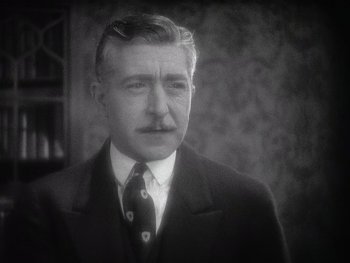Movie still from “The Jazz Singer” (1927), directed by Alan Crosland – An older man wearing a suit and a tie; Close Up shot, Low angle