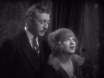 Movie still from “The Jazz Singer” (1927), directed by Alan Crosland – An old photo of a man and a woman; Close Up shot, Low angle