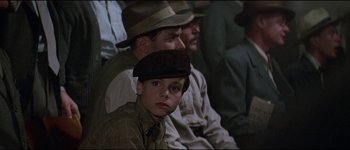 Movie still from “The Journey of Natty Gann” (1985), directed by Jeremy Kagan – A group of men sitting next to each other in a room; Close Up shot, High angle