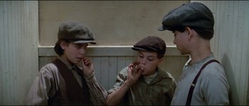 Movie still from “The Journey of Natty Gann” (1985), directed by Jeremy Kagan – A group of young men standing next to each other; Medium shot, High angle
