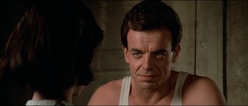 Movie still from “The Journey of Natty Gann” (1985), directed by Jeremy Kagan – A person wearing a tank top; Close Up shot, Over the shoulder angle