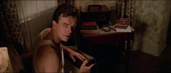 Movie still from “The Journey of Natty Gann” (1985), directed by Jeremy Kagan – A young man holding a book in his hands; Close Up shot, Low angle