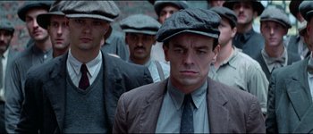 Movie still from “The Journey of Natty Gann” (1985), directed by Jeremy Kagan – A group of men wearing hats and suits; Close Up shot, Low angle