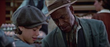 Movie still from “The Journey of Natty Gann” (1985), directed by Jeremy Kagan – An older man and a young girl looking at each other; Close Up shot, Over the shoulder angle