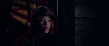 Movie still from “The Journey of Natty Gann” (1985), directed by Jeremy Kagan – A young boy wearing a hat looking at the camera; Close Up shot, Low angle