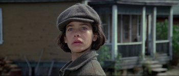 Movie still from “The Journey of Natty Gann” (1985), directed by Jeremy Kagan – A young woman wearing a hat and a coat; Close Up shot, Low angle
