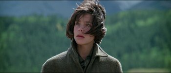 Movie still from “The Journey of Natty Gann” (1985), directed by Jeremy Kagan – A young woman with long brown hair wearing a coat; Close Up shot, High angle