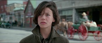Movie still from “The Journey of Natty Gann” (1985), directed by Jeremy Kagan – A young woman in a brown jacket and a horse; Close Up shot, Low angle