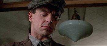 Movie still from “The Journey of Natty Gann” (1985), directed by Jeremy Kagan – A person wearing a hat; Close Up shot, Low angle