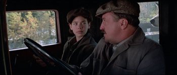 Movie still from “The Journey of Natty Gann” (1985), directed by Jeremy Kagan – A man and a woman sitting on a train; Close Up shot, Over the shoulder angle