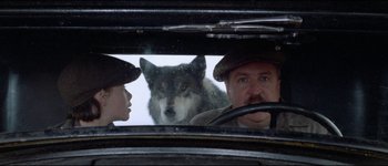 Movie still from “The Journey of Natty Gann” (1985), directed by Jeremy Kagan – A man and a woman looking at a dog through a car window; Close Up shot, Over the shoulder angle