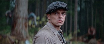 Movie still from “The Journey of Natty Gann” (1985), directed by Jeremy Kagan – A person wearing a hat; Close Up shot, Over the shoulder angle