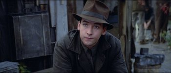 Movie still from “The Journey of Natty Gann” (1985), directed by Jeremy Kagan – A young man in a hat and a jacket; Close Up shot, High angle