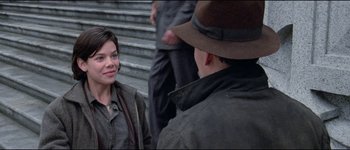 Movie still from “The Journey of Natty Gann” (1985), directed by Jeremy Kagan – A man and a woman are talking to each other outside; Medium shot, Over the shoulder angle