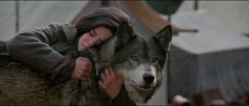 Movie still from “The Journey of Natty Gann” (1985), directed by Jeremy Kagan – A woman hugging a dog while it looks like she is holding it; Medium shot, High angle